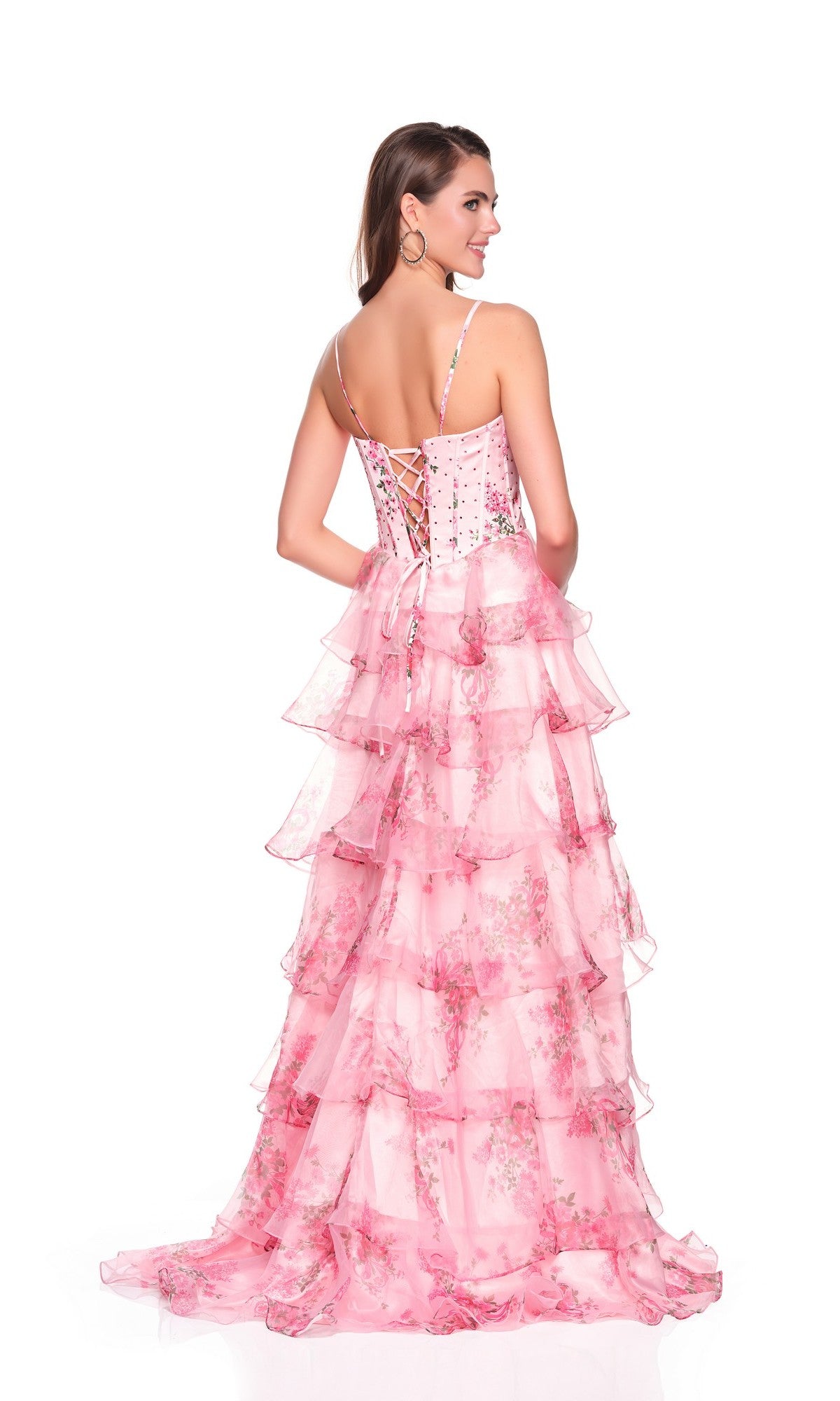 A woman faces away in the Dave and Johnny 12941 long prom dress, featuring a pink satin corset bodice and tiered chiffon A-line skirt, set against a white background.
